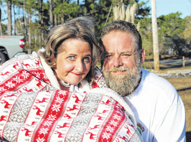 Gavin Stone | Daily Journal
                                Kelli and Kent Gillis at their home on Saturday following a parade of their friends and family wishing them well after their year-long ordeal.