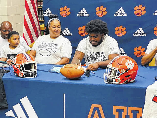 Family, friends and teammates support senior Jaydn Dickens as he commits to St. Augustine College to play football.
Contributed Photo