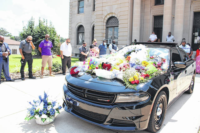 Gavin Stone | Daily Journal
Well wishers placed flowers on the hood of a Sheriffs Office cruiser parked in front of the Courthouse in honor of the passing of Sheriff James Clemmons.