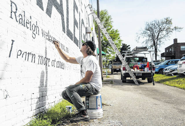 Scott Nurkin paints a mural.
                                 Contributed photo