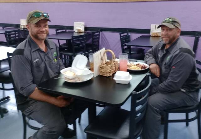 Justin Rayfield and Lonnie Lowery Jr. take a break for lunch at Oasis. Best place in Wadesboro for a home cooked meal, boasts Rayfield. Lowery agrees, Always plenty of food and always good.