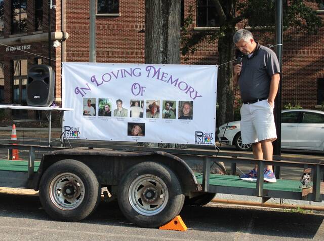 Commissioner Jason Gainey bows his head in prayer. I want to step aside for a minute and I want you to take a look at the banner behind me, this is far more important than who I am or who I represent. These are our friends and loved ones and family members that have been affected by drugs.