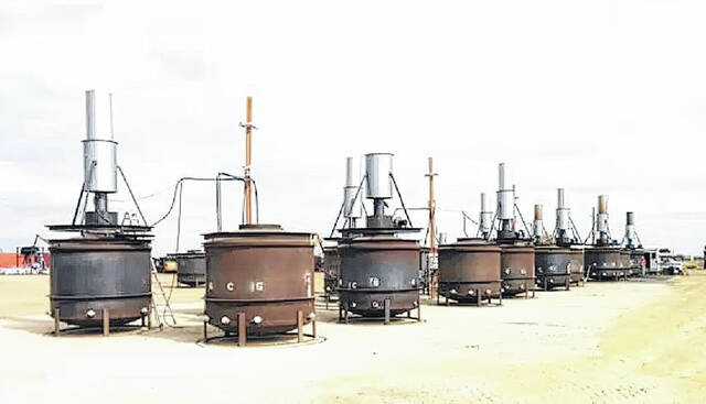 This picture shows an example of a row of pyrolysis kilns that will be used to produce biochar in a similar setup to what will be used by ITD.
                                 Photo courtesy of NCDEQ