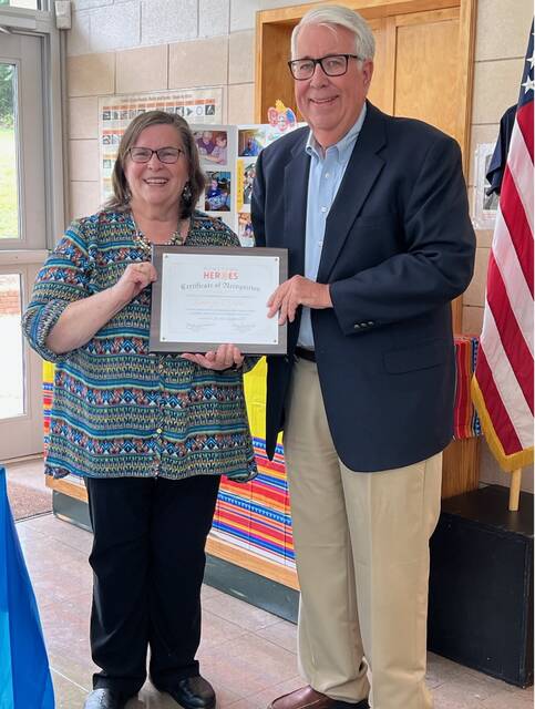 Wendy Efrid presents George Bower with the Rotarys Hometown Hero Award.