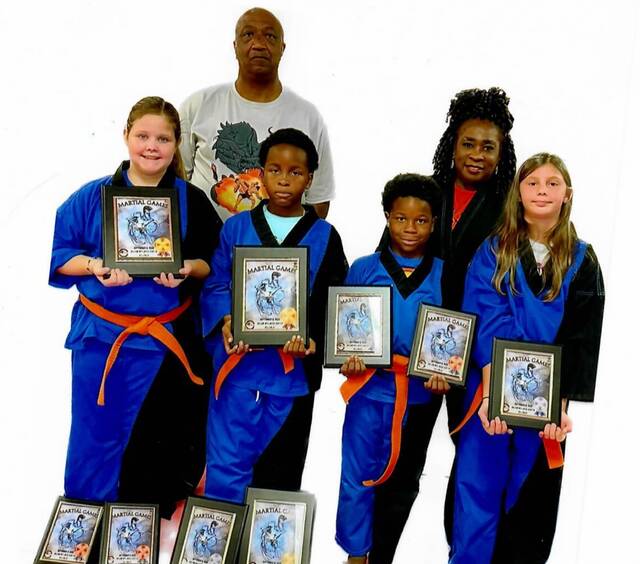 Four of the Ebony Dragons Martial Arts Academy competition team members traveled to Dillon, SC on Saturday, Sept. 9, 2023 to compete in their sixth tournament of the year. Pictured is (front row) Addison Jarrell, Tre Garth, Christian Garth and Adelynn Helms. In the second row is Master Ronnie Covington and Sensei Denise Watkins. The Ebony Dragons will host their own tournament on Oct. 7 at Anson Middle School at 9:00 a.m. For any questions, call Watkins at 910-206-3237.
                                 Submitted photo