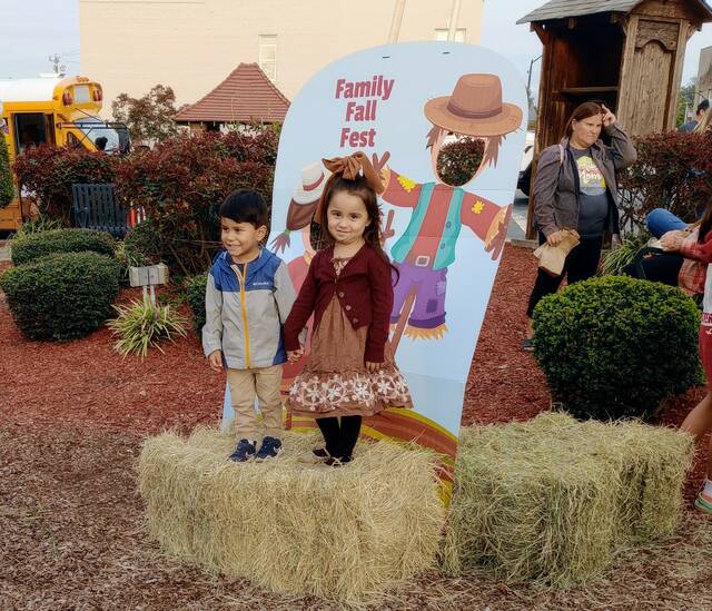 Bellani Granados and Leo Lugo took a moment to take a picture with a couple of scarecrows at the Friday, September 22, Fall Family Fun Fest.