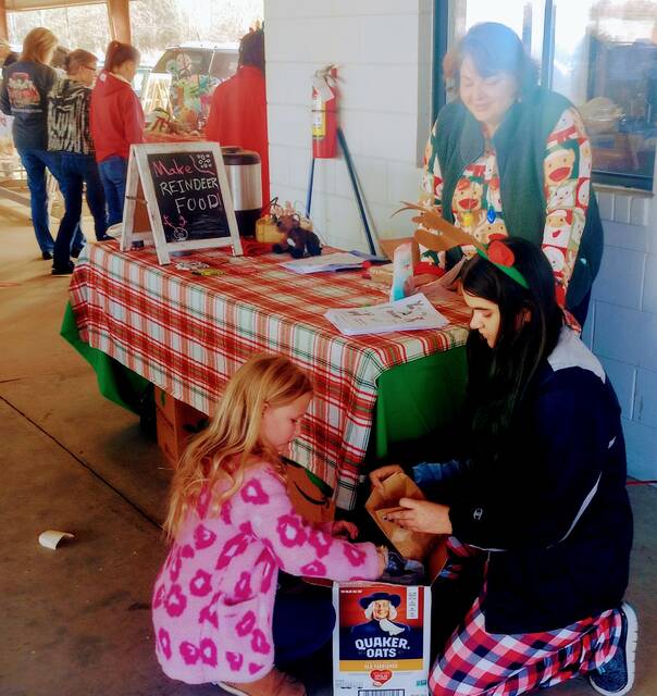 Laura and Jessica Laney helped little Miss Scarlet Lee get magic reindeer food ready for a visit from Rudolf and the gang.