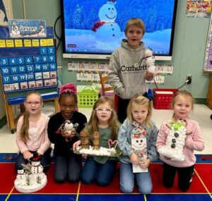 Kindergartners celebrate the winter season decorating snowmen
