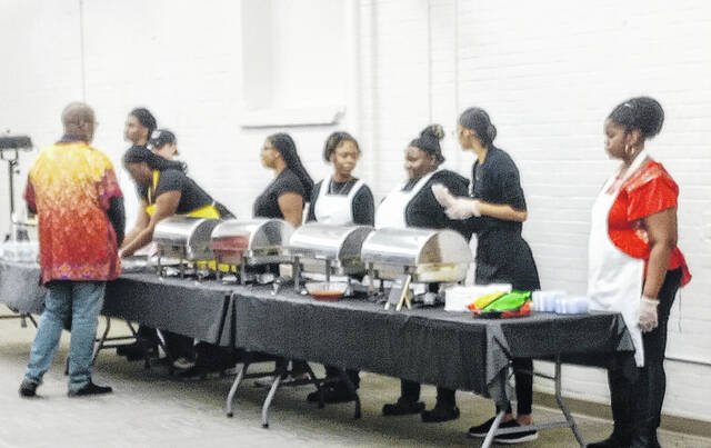 Lined up and ready to serve in true HOLLA! style; event Staff served Jamaican Jerk chicken wings, African meat pies, rice, and desserts.
Lauren Monica | Anson Record