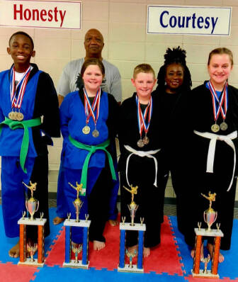 Pictured Left to Right is Dennis Boden, Addison Jarrell, Parker Brown, and Tina Andronovich. Back Row, left ot right is Master Ronnie Covington and Sensei Denise Watkins. Not pictured are Trey Garth, Christian Garth, and Lorrenzo Hubbard.
Submitted to the Record