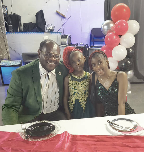 Pastor Tobias Wall with his daughters Trinity and Jada Wall
                                 Lauren Monica | Anson Record