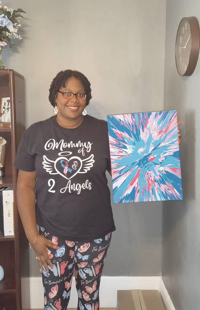 Tasha Coleman proudly shows off her spin art creation by local artist Toni Carpenter Rorie. The artwork was inspired by Coleman, in recognition of October 15 Pregnancy and Infancy Loss Awareness Day.
Lauren Monica | Anson Record