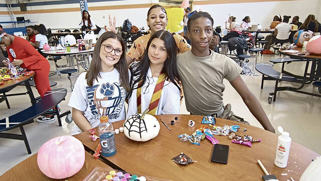 Varsity Cheer Captain Mara Veth and Ceyvon McNair pose with fellow cheer team members
Lauren Monica | Anson Record