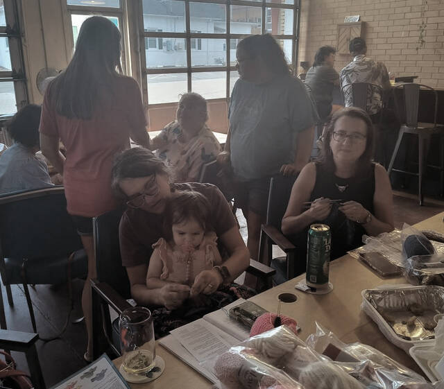Heather Edwards (seated left) and her adopted Shop Goddaughter Raelyn work on a very special project together
Lauren Monica | Anson Record