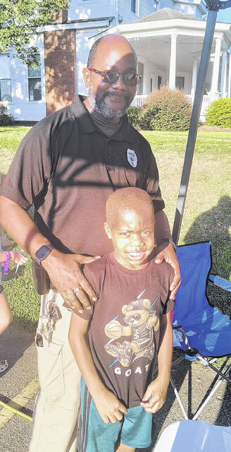 Chief Nigel Bristow with his son London. Chief Bristow said, We are happy to be participating, it is a joy to be out here in our community.