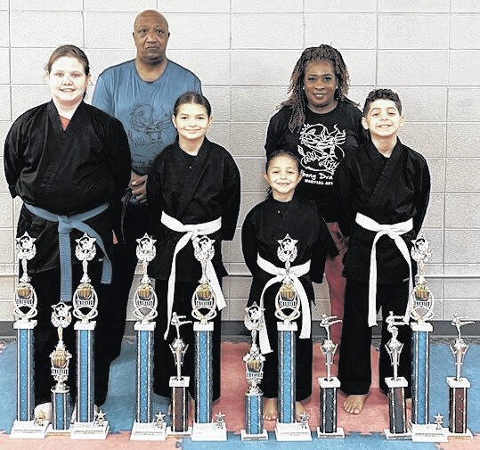 Six students with the Ebony Dragons Martial Arts Academy competition team traveled to Rock Hill, SC August 9, 2025, to compete in the martial arts Explosion Karate Tournament. Pictured left to right in the front row are Dragons: Addison Jerrell, Ava Roscoe,Emma Roscoe, and Jase Roscoe. Back Row Dragons pictured left to right are: Master Ronnie Covington, and Sensei Denise Watkins. Not pictured is Dragon Tre Garth.
Ebony Dragons