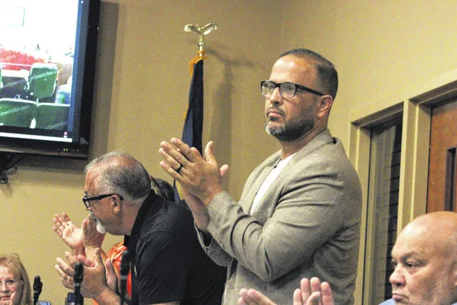 Lumbee Tribal Councilman Jody Bullard, center, chair of councils Health and Human Services Committee, and other members of council stand and applaud following approval of an ordinance which declares clean drinking water as a fundamental right for Lumbee people during Thursdays Tribal Council meeting in Pembroke.
                                 Chris Stiles | Champion Media